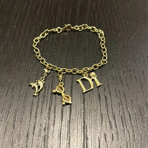 Diamonds International gold chain dolphin, sunglasses, logo charm bracelet. New.